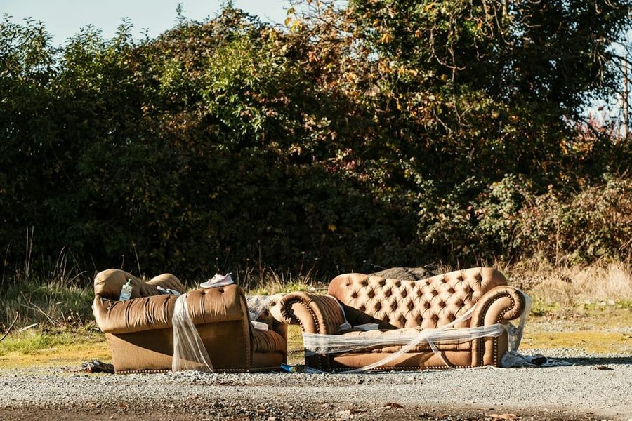 An old sofa left outside a residential block awaiting collection