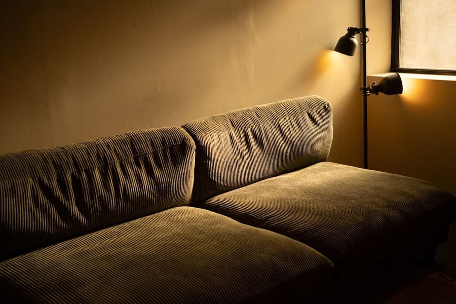 Tan leather power recliner sofa with USB charging in a sunlit Singapore rental apartment living room